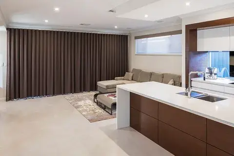 Brown blockout curtains in an open-plan living room