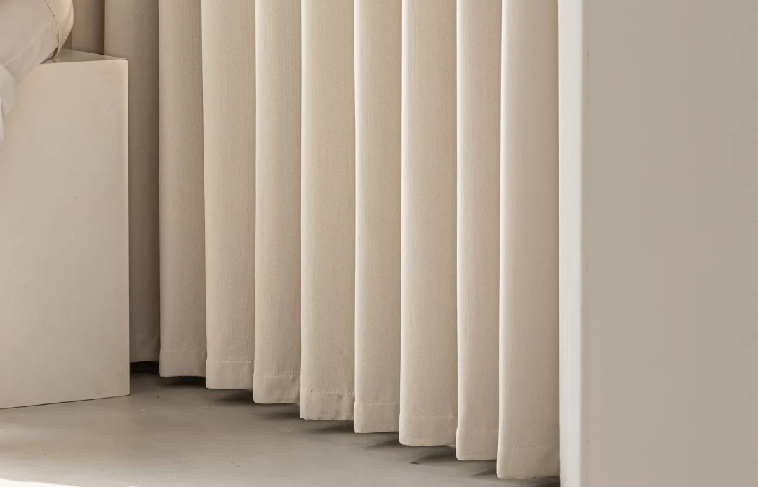Cream blockout curtains close up in a soft neutral room