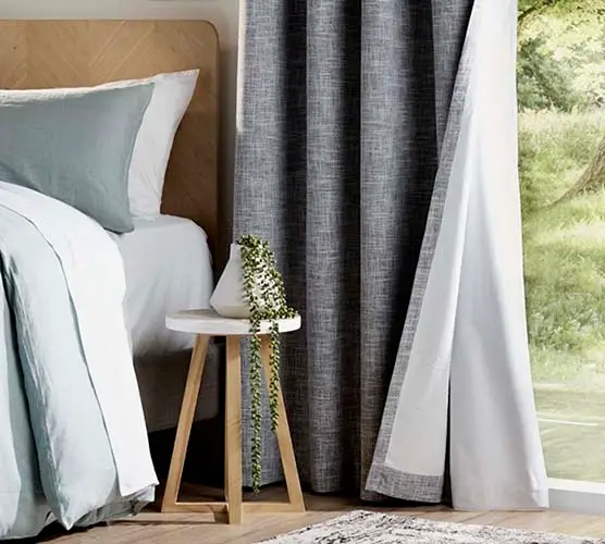 Blockout curtain fabric beside a bedroom window