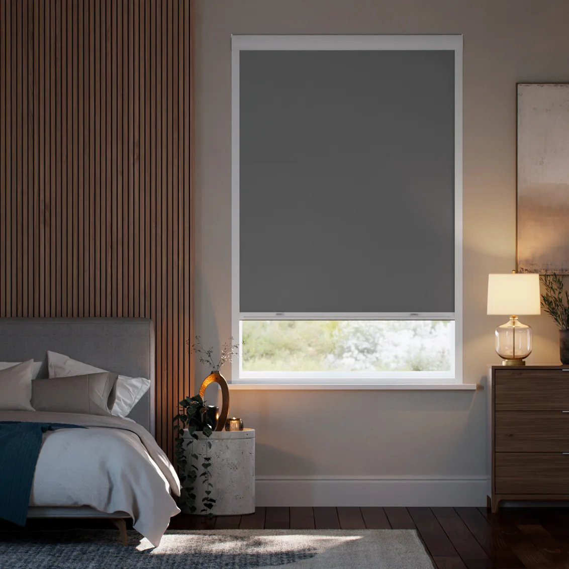 Dark grey blockout roller blind fitted over a bedroom window