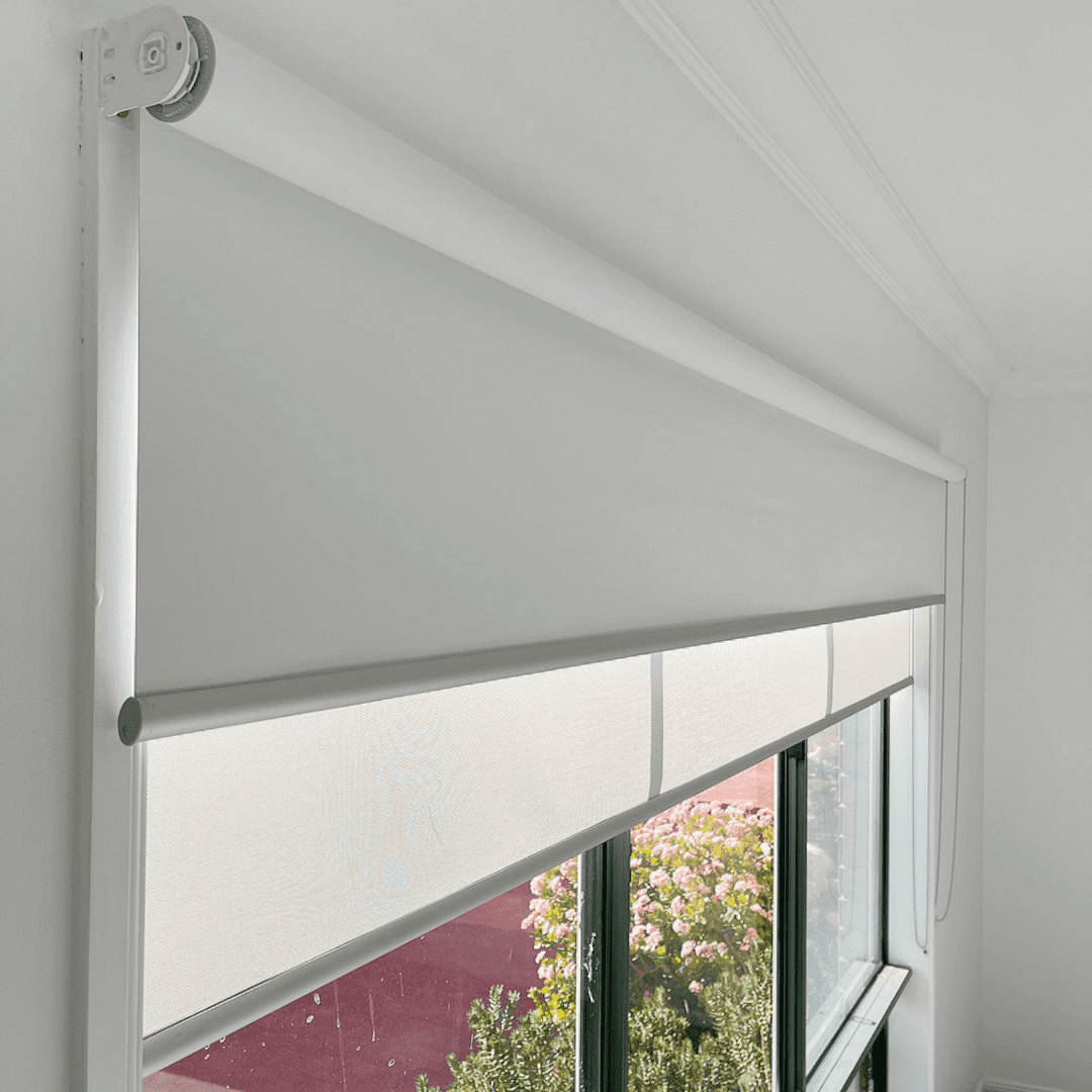 White double roller blinds fitted to a window with separate blockout and sunscreen layers