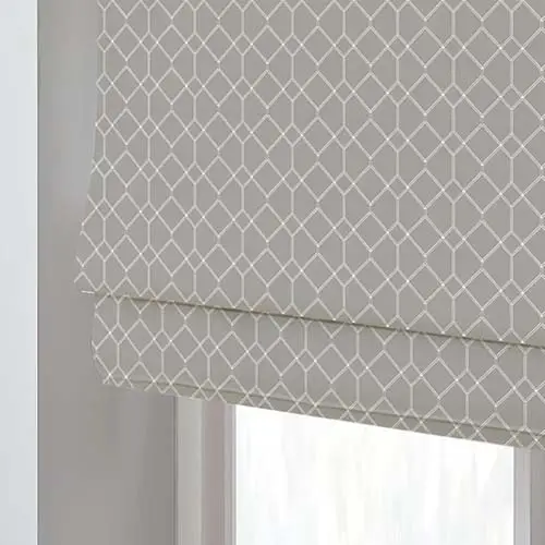 Close up of a patterned Roman blind fabric fitted to a window