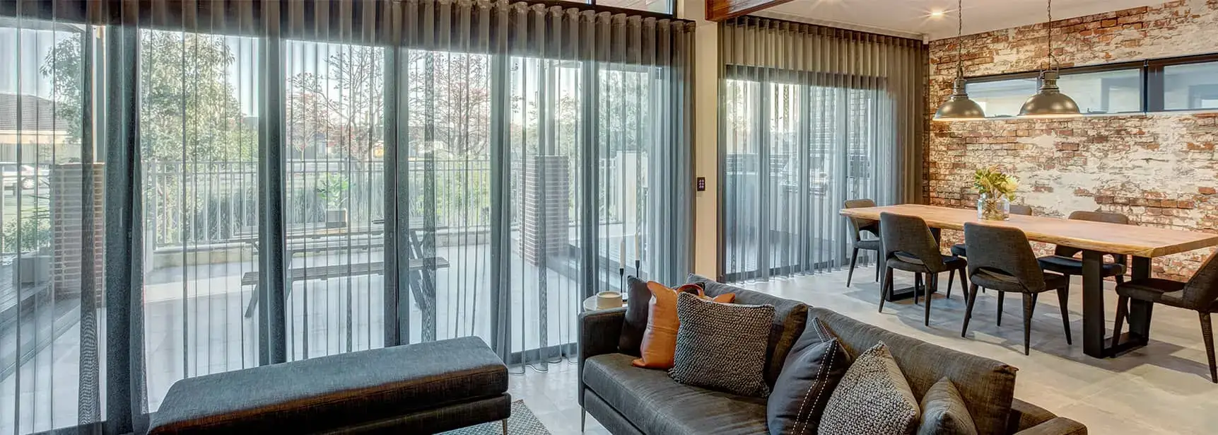 Sheer curtains across bifold doors in a bright living room